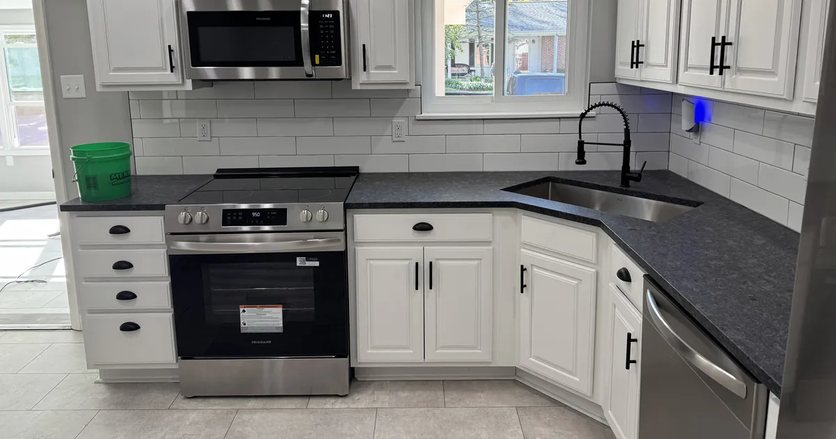 Stainless steel range and oven in a clean white kitchen